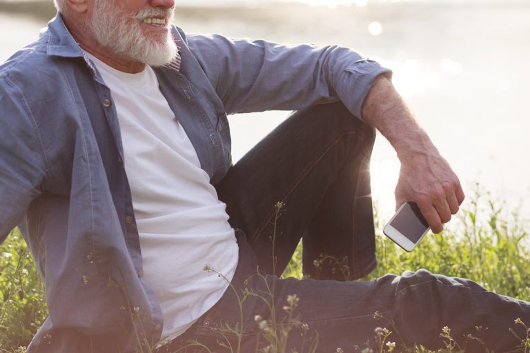 older male sitting on grass